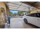 Attached two-car garage offering ample space for parking and storage, with an open door view of the neighborhood at 10203 Arlington Abby St, Las Vegas, NV 89183