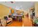 Open kitchen featuring a breakfast bar, hardwood floors, and plenty of natural light at 10203 Arlington Abby St, Las Vegas, NV 89183