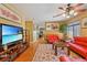 Cozy living room with hardwood floors, a patterned rug, and bright red sofas at 10203 Arlington Abby St, Las Vegas, NV 89183