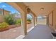 Charming covered patio showcases an inviting outdoor space with manicured landscaping and decorative outdoor lighting at 10203 Arlington Abby St, Las Vegas, NV 89183