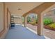 Covered patio featuring stucco columns and a well-maintained landscaped backyard, offering a serene outdoor living space at 10203 Arlington Abby St, Las Vegas, NV 89183