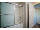 Shower-tub with glass doors, and a view of the doorway and closet at 1136 Paradise Garden Dr, Henderson, NV 89002