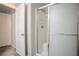 Bright bathroom featuring a glass-enclosed shower with a built-in seat and a white door at 1136 Paradise Garden Dr, Henderson, NV 89002