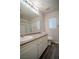Well-lit bathroom with laminate counters, white cabinets, and vinyl flooring at 1136 Paradise Garden Dr, Henderson, NV 89002