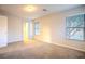 Cozy bedroom featuring neutral carpet, open doorway and multiple windows at 1136 Paradise Garden Dr, Henderson, NV 89002
