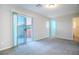 This carpeted bedroom features a sliding glass door that leads to a private balcony at 1136 Paradise Garden Dr, Henderson, NV 89002