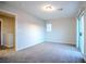 This carpeted bedroom includes an adjoining bathroom, and a sliding glass door at 1136 Paradise Garden Dr, Henderson, NV 89002