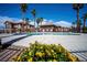 Community pool surrounded by lush landscaping, and beautiful palm trees at 1136 Paradise Garden Dr, Henderson, NV 89002