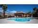 Community pool offers a refreshing escape, surrounded by palm trees and a well-maintained pool house at 1136 Paradise Garden Dr, Henderson, NV 89002