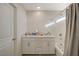 Bathroom featuring a double sink vanity, tiled shower/tub, and a framed mirror with bright lighting at 1317 Hopespring Loop Ave, North Las Vegas, NV 89084