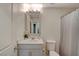 Bathroom featuring a single sink vanity, framed mirror, toilet, and a shower/tub combination with a curtain at 1317 Hopespring Loop Ave, North Las Vegas, NV 89084