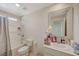 Well-lit bathroom with a shower-tub combo, single sink vanity, and decorative mirror at 1317 Hopespring Loop Ave, North Las Vegas, NV 89084