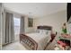 Cozy bedroom featuring a tufted headboard bed, soft gray bedding, and a well-lit window with neutral drapes at 1317 Hopespring Loop Ave, North Las Vegas, NV 89084