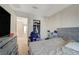 Bedroom with a dresser and TV, a view into a hallway, and closet space with clothing and shoes at 1317 Hopespring Loop Ave, North Las Vegas, NV 89084