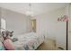 Bright bedroom featuring a white bed, playful bedding, and a chandelier light fixture at 1317 Hopespring Loop Ave, North Las Vegas, NV 89084