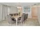 Elegant dining room featuring a stylish chandelier and a contemporary glass-top table with seating for eight at 1317 Hopespring Loop Ave, North Las Vegas, NV 89084