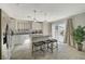 Modern kitchen with white cabinets, granite countertops, a center island, and stainless steel appliances at 1317 Hopespring Loop Ave, North Las Vegas, NV 89084