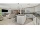 Open-concept kitchen featuring white cabinets, granite countertops and a seamless flow to the dining and living area at 1317 Hopespring Loop Ave, North Las Vegas, NV 89084