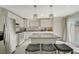 Well-lit kitchen featuring white cabinetry, granite countertops, a center island, and stainless steel appliances at 1317 Hopespring Loop Ave, North Las Vegas, NV 89084