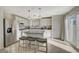 Bright kitchen with stainless steel appliances, pendant lighting and a gray granite island with seating at 1317 Hopespring Loop Ave, North Las Vegas, NV 89084