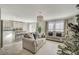 Open-concept living area with a kitchen island, modern lighting, and access to the backyard at 1317 Hopespring Loop Ave, North Las Vegas, NV 89084