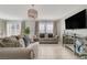 Cozy living room with comfortable sofas, a mirrored console, and a mounted TV for relaxation at 1317 Hopespring Loop Ave, North Las Vegas, NV 89084