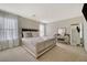 Bright main bedroom with a stylish bed frame, natural light from large windows, and vanity with decorative mirror at 1317 Hopespring Loop Ave, North Las Vegas, NV 89084