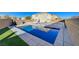 Backyard with a beautiful in-ground swimming pool, concrete deck, and privacy fence at 1317 Hopespring Loop Ave, North Las Vegas, NV 89084