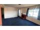 Spacious living room with blue carpets, a fireplace, and natural light from the window at 1701 E Katie Ave # 91, Las Vegas, NV 89119