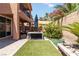 Spacious backyard featuring artificial turf, an umbrella, and mature landscaping at 174 Augusta Course Ave, Las Vegas, NV 89148