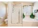 Bright bathroom featuring a glass-enclosed shower, a soaking tub, and a neutral color scheme for a spa-like feel at 174 Augusta Course Ave, Las Vegas, NV 89148