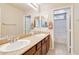 Bathroom with double sinks, granite countertops, and a view into the tiled shower/bath at 174 Augusta Course Ave, Las Vegas, NV 89148