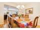 Bright dining room with wood floors, updated lighting and access to other living spaces at 174 Augusta Course Ave, Las Vegas, NV 89148