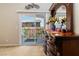 Close-up of decorative dresser featuring an ornate mirror, flowers, and access to the outdoor balcony at 174 Augusta Course Ave, Las Vegas, NV 89148