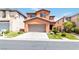 Two-story home featuring a well-manicured lawn and a two-car garage at 174 Augusta Course Ave, Las Vegas, NV 89148