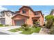 Charming two-story home featuring a well-manicured lawn, two-car garage and tasteful desert landscaping at 174 Augusta Course Ave, Las Vegas, NV 89148