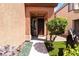 Inviting entryway with a decorative tree and a pathway leading to a stylish front door at 174 Augusta Course Ave, Las Vegas, NV 89148