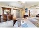 Bright main bedroom highlighting a decorative dresser, plush bed, and ensuite bathroom with stylish barn door at 174 Augusta Course Ave, Las Vegas, NV 89148