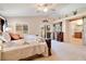Inviting main bedroom with balcony access, featuring a decorative dresser, and an ensuite bathroom at 174 Augusta Course Ave, Las Vegas, NV 89148