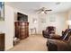Cozy sitting room featuring comfortable leather armchairs, decorative wall art, and a ceiling fan for added comfort at 174 Augusta Course Ave, Las Vegas, NV 89148