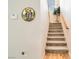 Carpeted staircase with wooden handrail leading to the second level of the home at 174 Augusta Course Ave, Las Vegas, NV 89148
