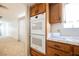 A view of the kitchen with stainless double ovens, tile countertop and backsplash, and wooden cabinetry at 2004 Canterbury Dr Dr, Las Vegas, NV 89119