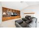 A well lit living room featuring a fireplace, built in bookshelves, a dark grey sofa, and carpeted floors at 2004 Canterbury Dr Dr, Las Vegas, NV 89119