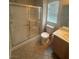 Bathroom featuring a glass-enclosed shower, a toilet, and a vanity at 2025 Cary Grant Ct, Las Vegas, NV 89142
