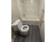 Bathroom featuring a bathtub with marble-look tile and new toilet at 2025 Cary Grant Ct, Las Vegas, NV 89142