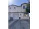 Two-story home featuring a private garage, neutral stucco facade, and well-lit entryway at 2025 Cary Grant Ct, Las Vegas, NV 89142