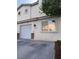 Exterior view of a two-story townhome with garage and neutral paint; great natural light at 2025 Cary Grant Ct, Las Vegas, NV 89142