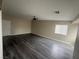 Open living room with gray wood flooring, neutral walls, ceiling fan, and natural light at 2025 Cary Grant Ct, Las Vegas, NV 89142