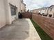 Concrete patio featuring turf and a brick wall for added privacy at 2025 Cary Grant Ct, Las Vegas, NV 89142