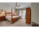 Spacious bedroom featuring a four-poster bed, ceiling fan, and sliding glass doors to the pool area at 209 Tamarack Dr, Henderson, NV 89002